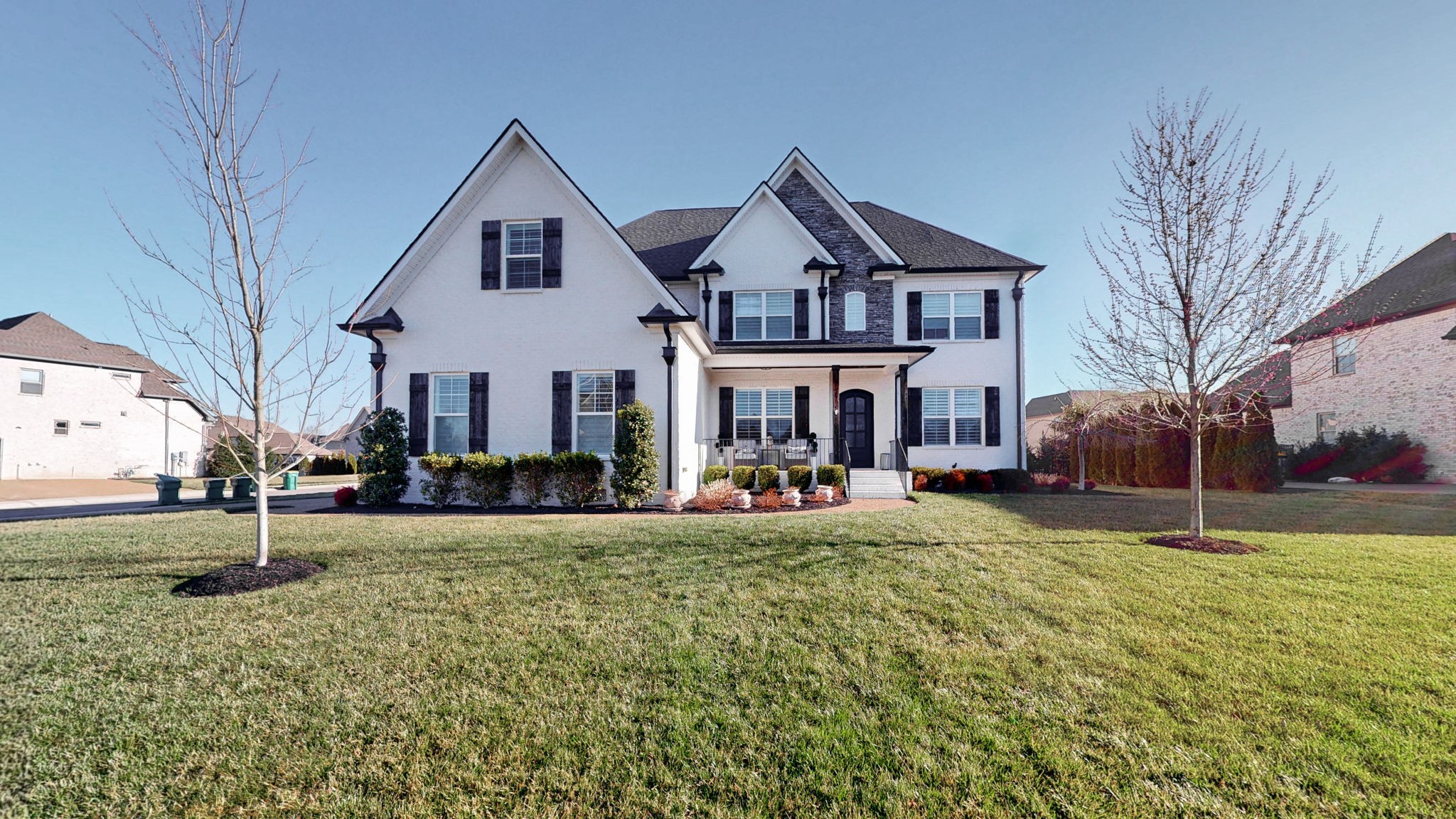 a view of a house with a yard and pathway
