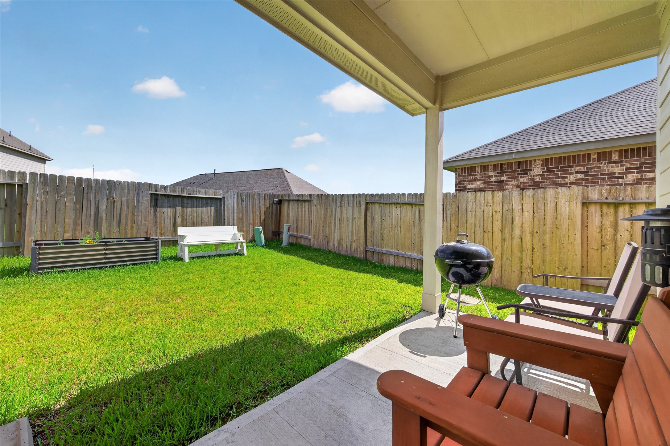 1329 Red Hills Drive Rosharon, TX 77583 - Photo 23 of 27 Charming backyard with a covered patio, lush green lawn, and a cozy seating area. Perfect for outdoor relaxation and entertaining.