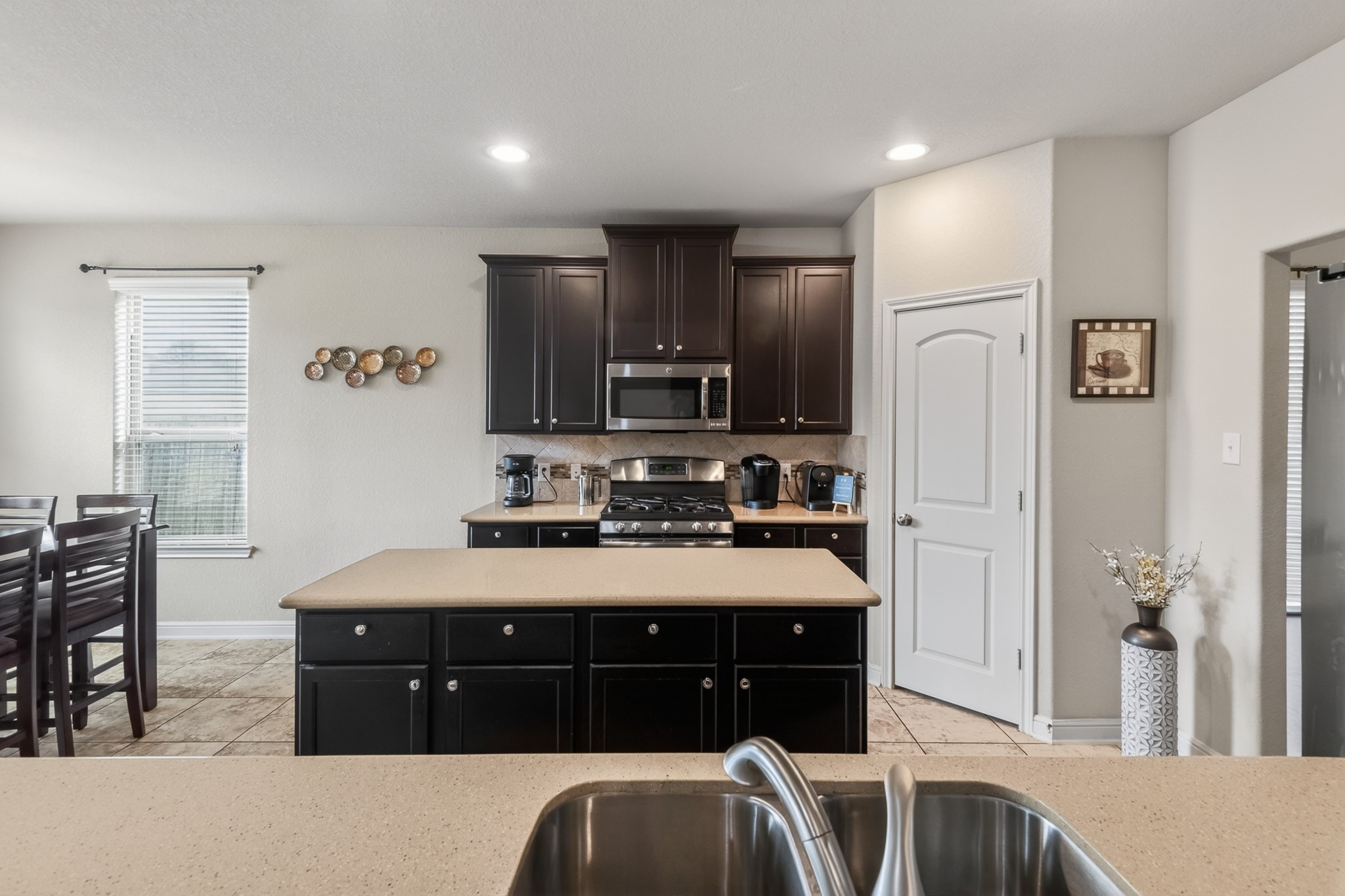 24711 East Burnaby Circle Spring, TX 77373 - Photo 8 of 20 a kitchen with stainless steel appliances granite countertop a stove a sink and a refrigerator
