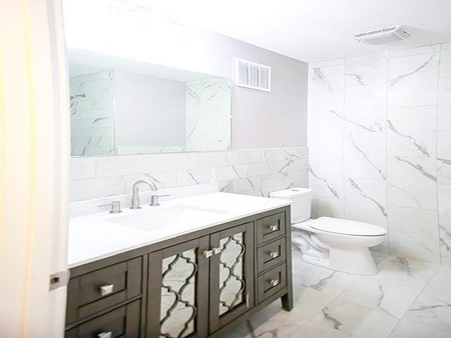 1906 Pennel Road Memphis, TN 38116 - Photo 16 of 38 a bathroom with a sink a toilet and a mirror