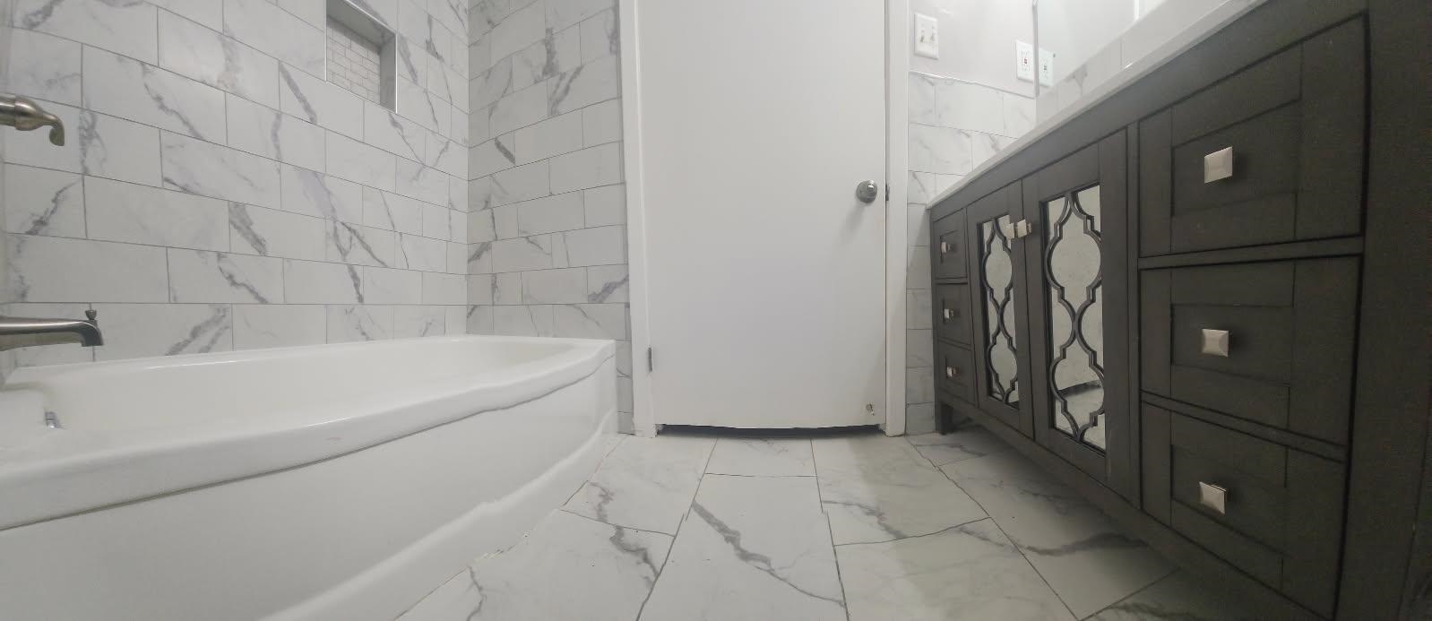 1906 Pennel Road Memphis, TN 38116 - Photo 17 of 38 a spacious bathroom with a bathtub and shower