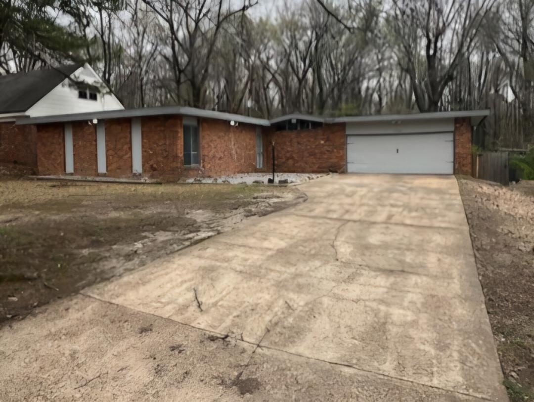 1906 Pennel Road Memphis, TN 38116 - Photo 2 of 38 a front view of a house with a yard and garage