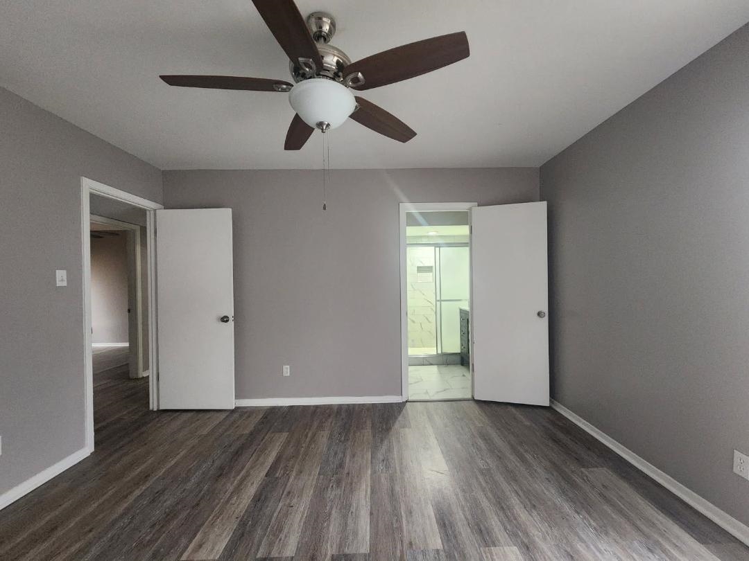 1906 Pennel Road Memphis, TN 38116 - Photo 25 of 38 an empty room with wooden floor fan and windows