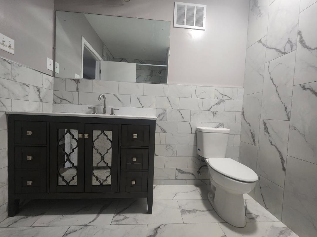 1906 Pennel Road Memphis, TN 38116 - Photo 28 of 38 a bathroom with a toilet and a sink