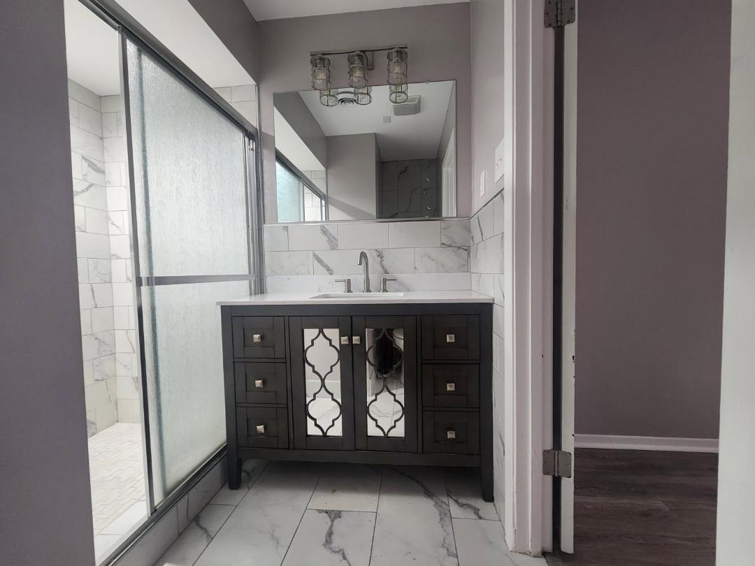 1906 Pennel Road Memphis, TN 38116 - Photo 29 of 38 a bathroom with a sink and a mirror