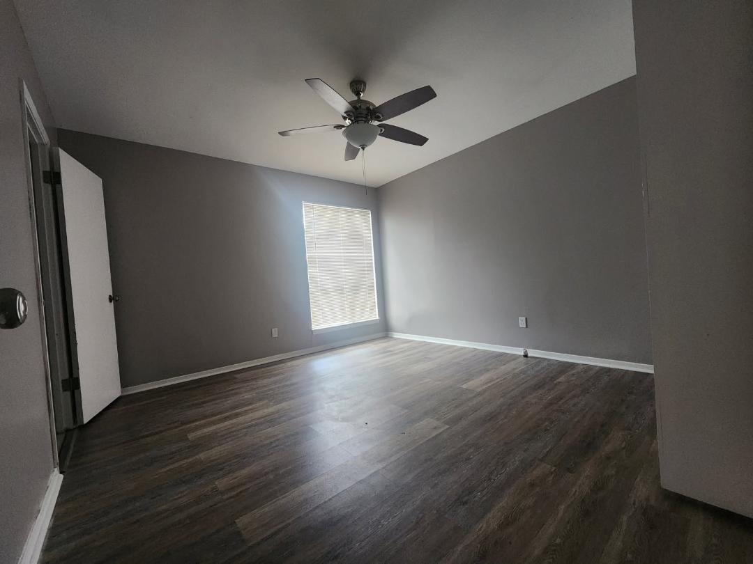 1906 Pennel Road Memphis, TN 38116 - Photo 32 of 38 an empty room with wooden floor fan and windows