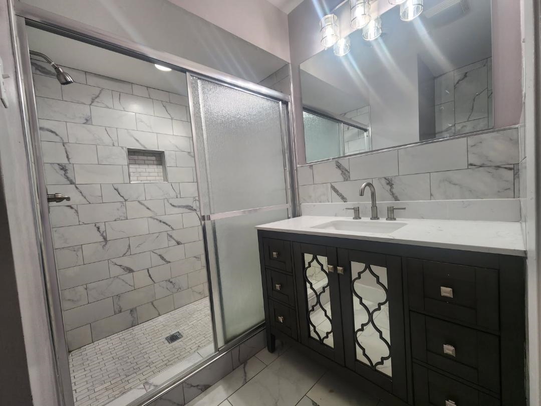 1906 Pennel Road Memphis, TN 38116 - Photo 34 of 38 a bathroom with a sink and a mirror