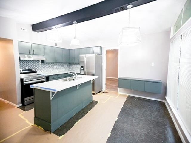 1906 Pennel Road Memphis, TN 38116 - Photo 5 of 38 a kitchen with kitchen island a sink stove and refrigerator