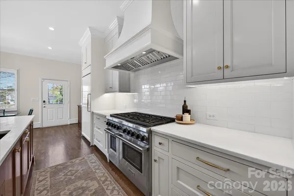 a kitchen with granite countertop a stove and a sink