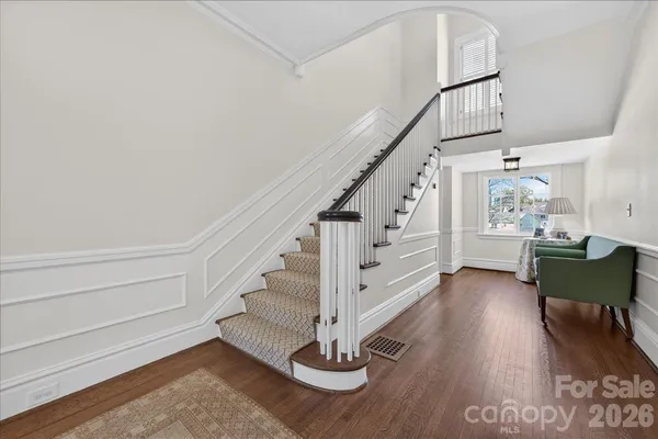 a view of entryway and hall with wooden floor
