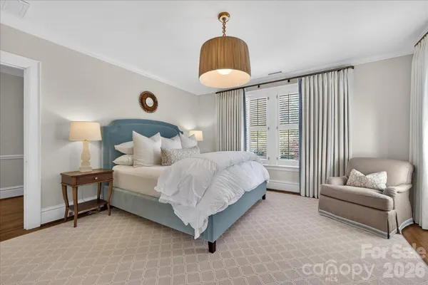 a bedroom with bed couch and window