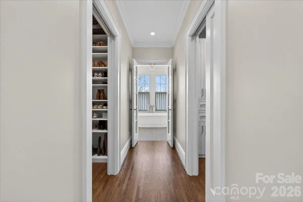 a view of hallway with wooden floor and staircase