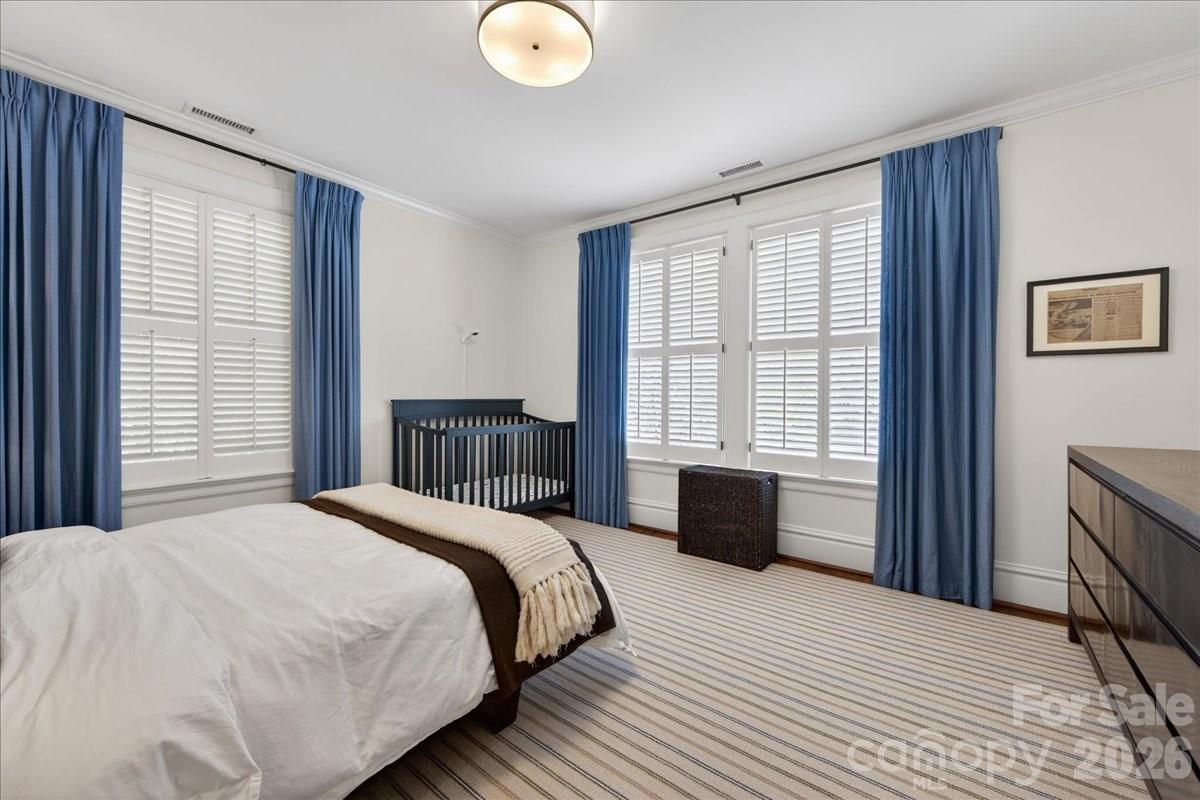 700 Queens Road Charlotte, NC 28207 - Photo 31 of 41 a bedroom with a large bed and a window