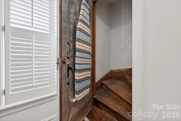 a view of hallway with a rug and a window