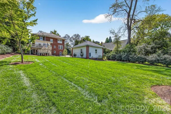 a view of a house with a yard and garage