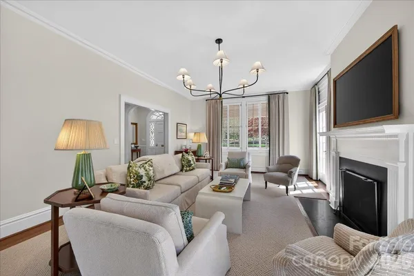 a living room with furniture a fireplace and a flat screen tv
