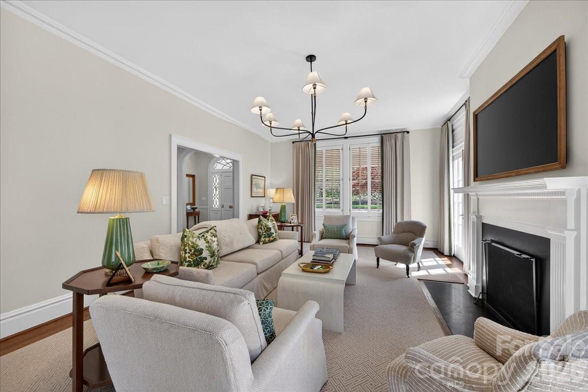 700 Queens Road Charlotte, NC 28207 - Photo 6 of 41 a living room with furniture a fireplace and a flat screen tv