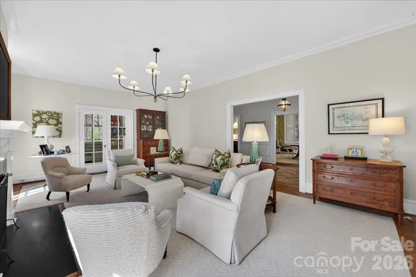 a living room with furniture chandelier and a chandelier
