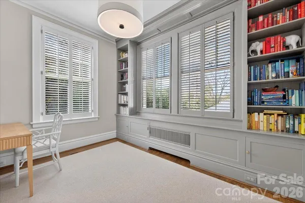 a view of an empty room with cabinet and a window