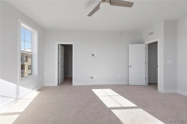 a view of an empty room with windows