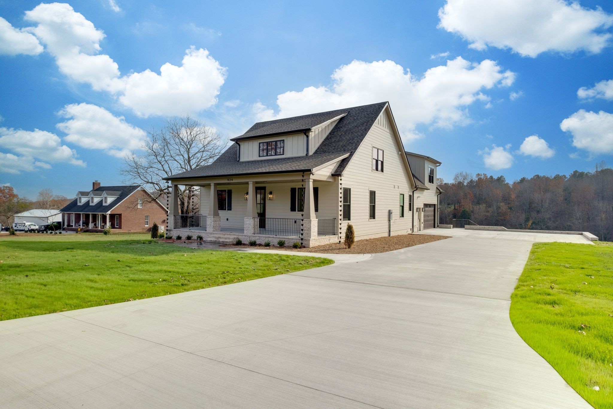 924 Hafner Road Charlotte, TN 37036 - Photo 61 of 79 a front view of a house with a garden and trees