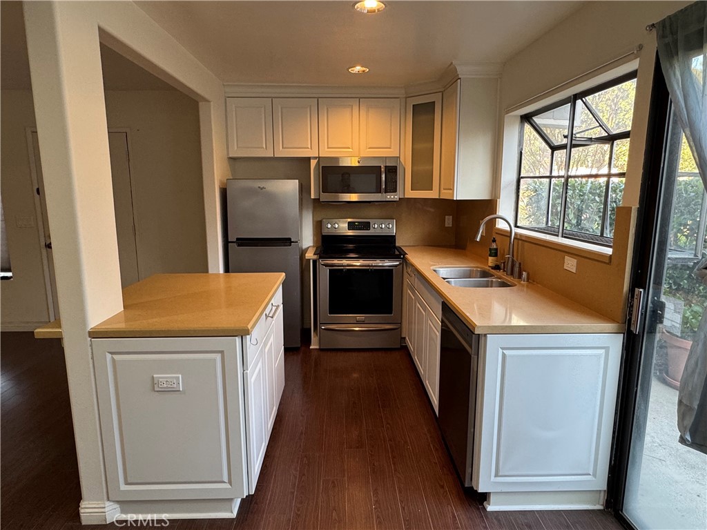 211 Springview Irvine, CA 92620 - Photo 5 of 12 a kitchen with a stove a sink and a refrigerator