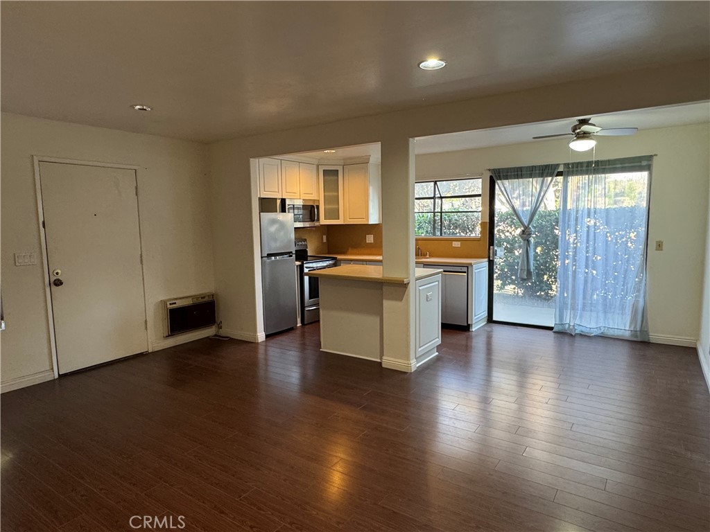 211 Springview Irvine, CA 92620 - Photo 8 of 12 an empty room with wooden floor and outdoor view