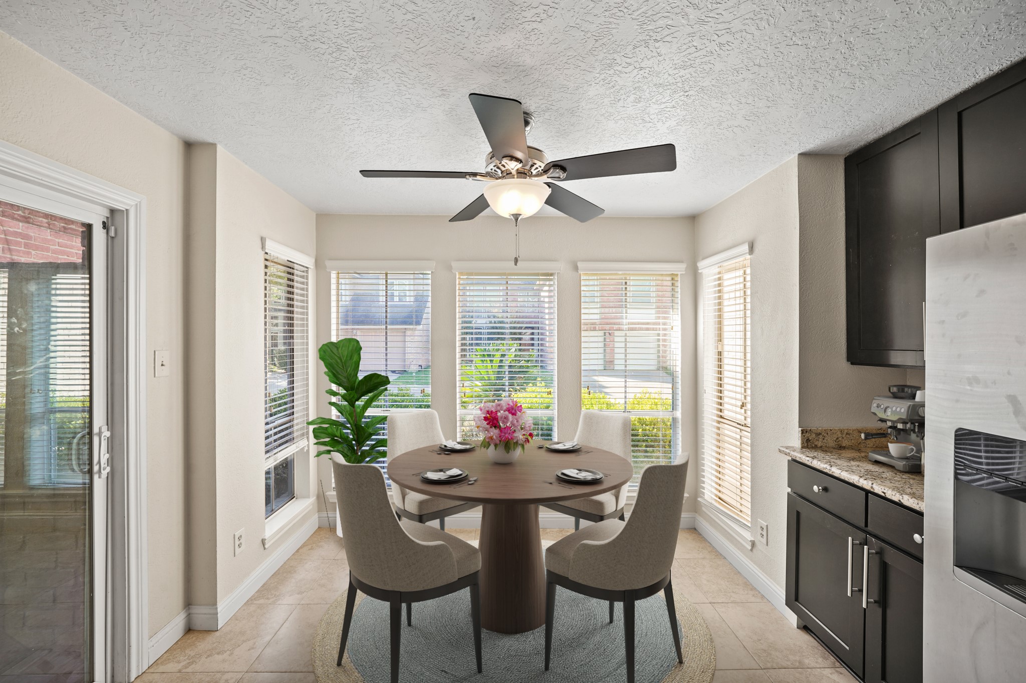 1641 Beaconshire Houston, TX 77077 - Photo 14 of 27 Virtually Staged: This charming breakfast area is also great for enjoying a solo cup of coffee or casual dining with the family. It is surrounded by windows with privacy blinds, and a ceiling fan.