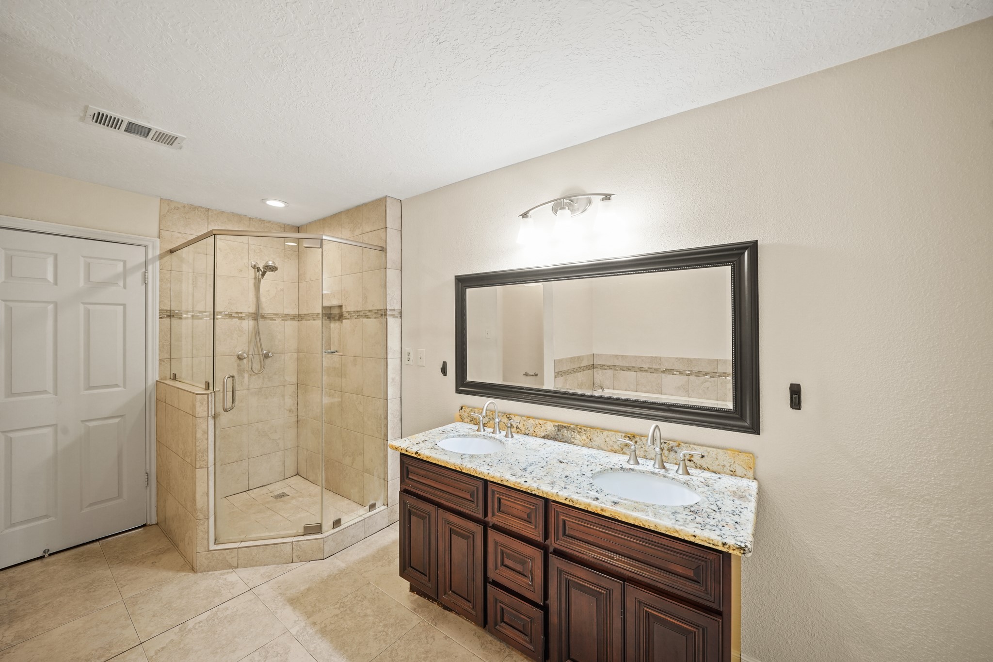1641 Beaconshire Houston, TX 77077 - Photo 10 of 27 The granite countertop vanity adds both style and functionality, and the private water closet is tucked conveniently behind a partial wall for added privacy.