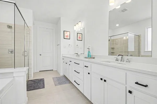 a bathroom with a double vanity sink and mirror