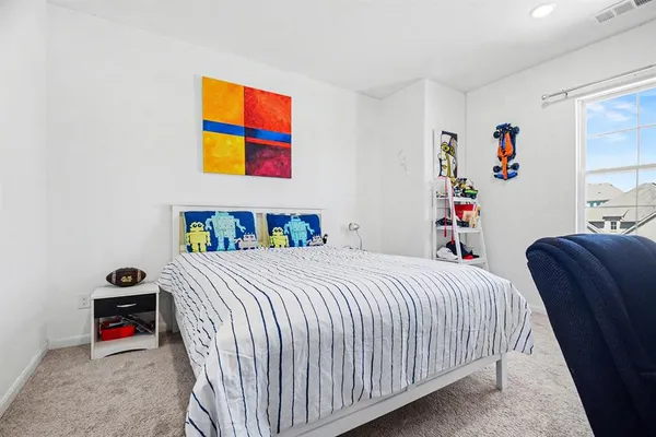 a bedroom with a bed and dresser