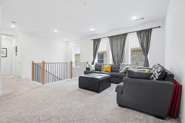 a living room with furniture and floor to ceiling window