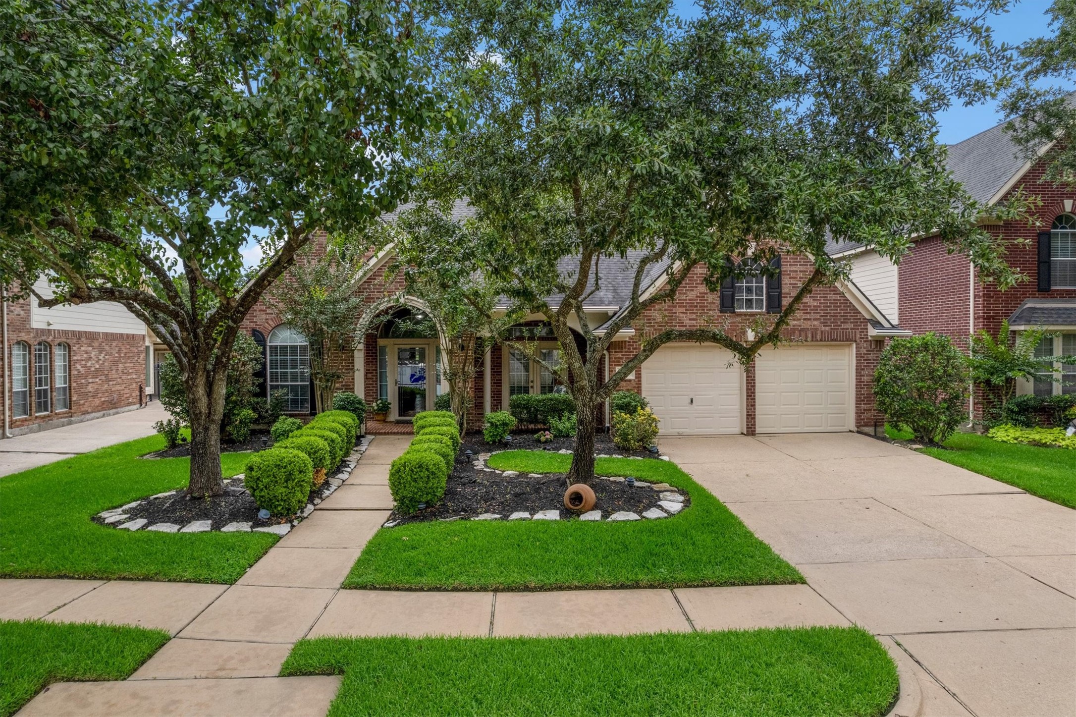 9406 Lochflora Drive Spring, TX 77379 - Photo 3 of 49 a front view of a house with a yard and trees