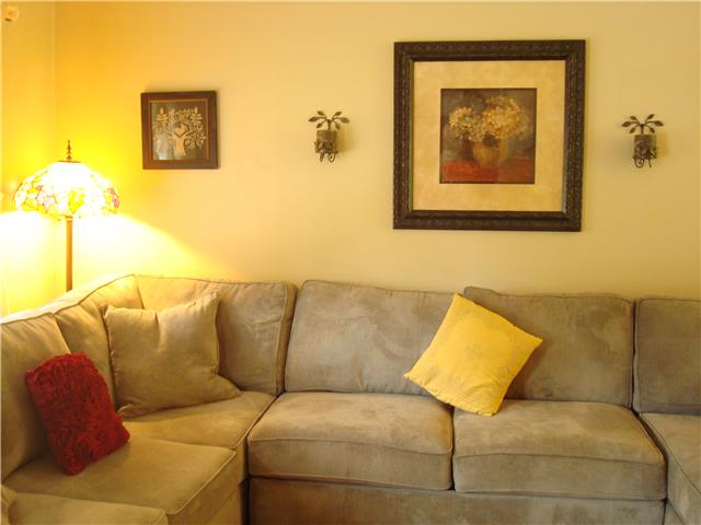 1113 Jacksons View Road Hermitage, TN 37076 - Photo 6 of 12 a blue couch sitting next to a blue wall with a book