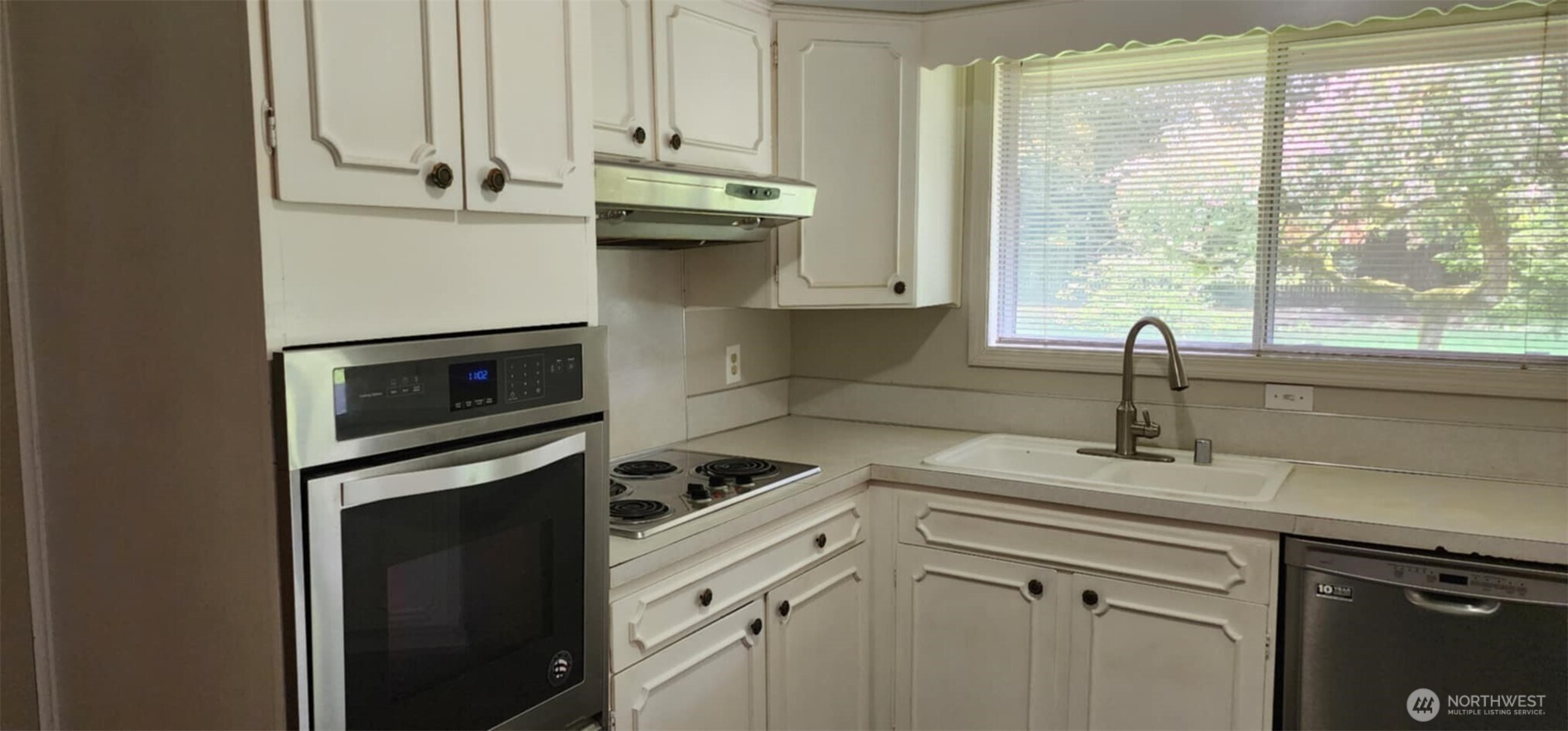 314 Insel Road Woodland, WA 98674 - Photo 21 of 32 a kitchen with stainless steel appliances a sink a stove and white cabinets