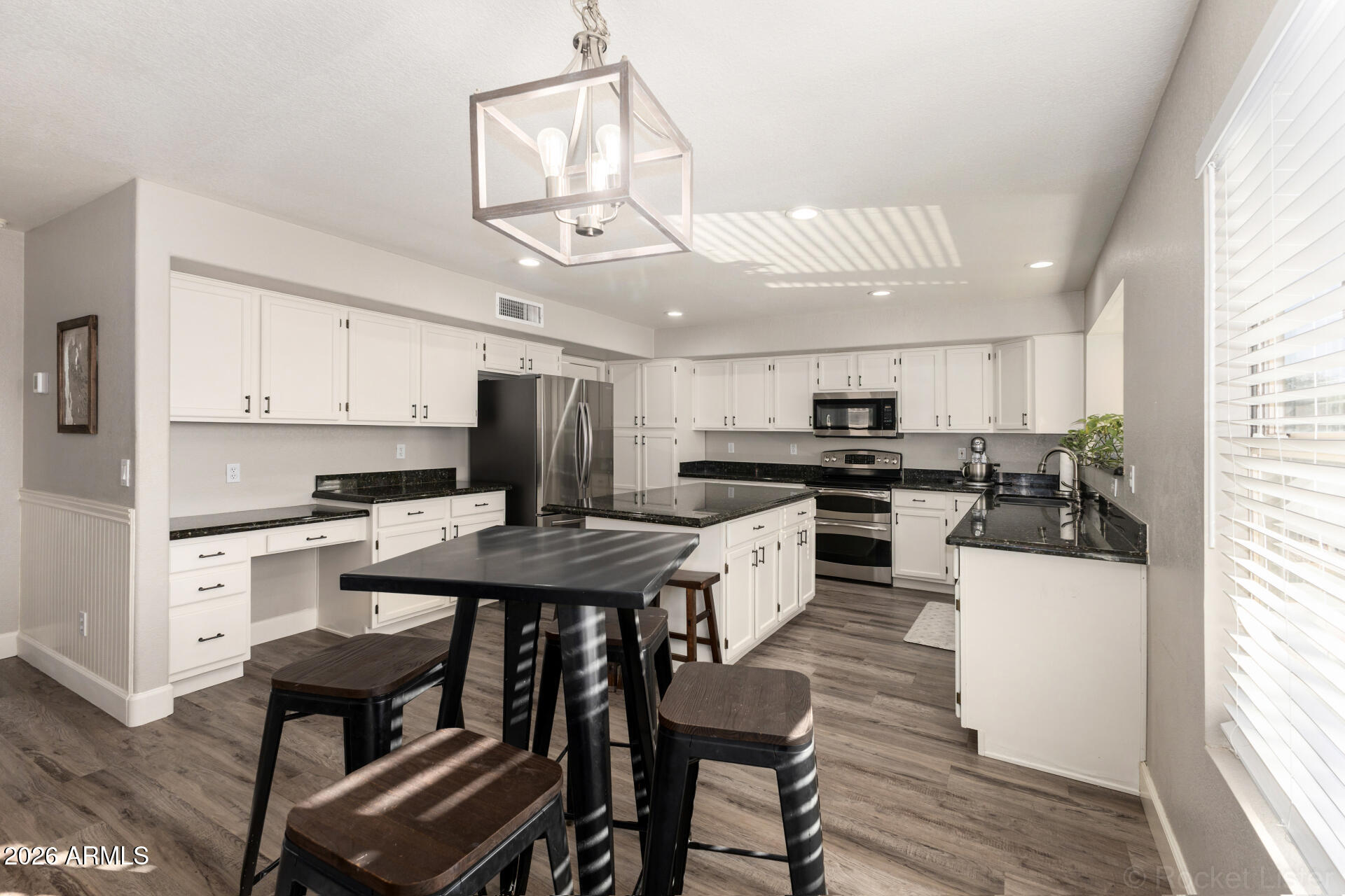 314 South Sandstone Street Gilbert, AZ 85296 - Photo 24 of 58 a kitchen with stainless steel appliances kitchen island granite countertop a sink and cabinets
