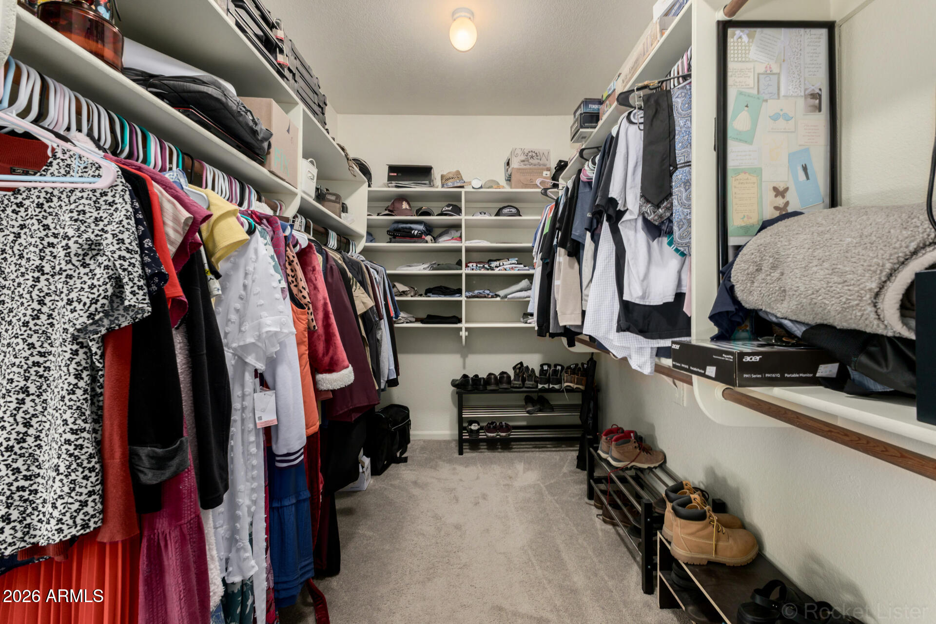 314 South Sandstone Street Gilbert, AZ 85296 - Photo 33 of 58 a view of walk in closet with clothes and shoes