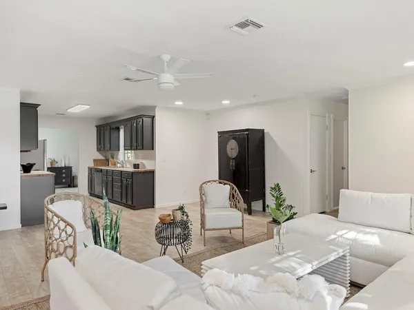 a living room with furniture and kitchen view