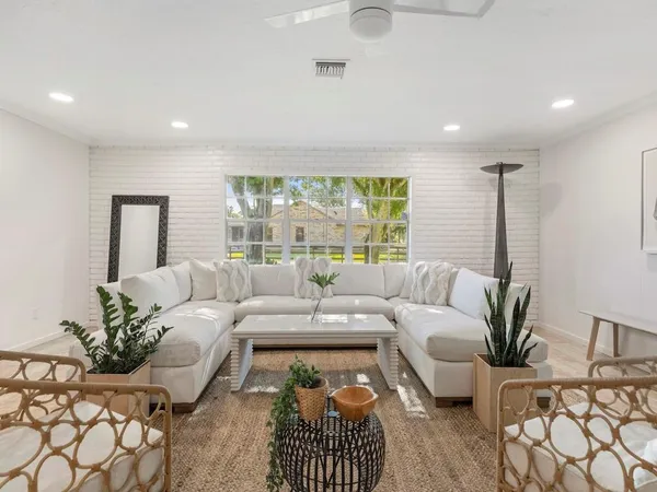 a living room with furniture or couch and a large window