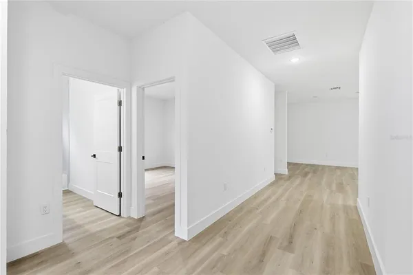 a view of a room with wooden floor