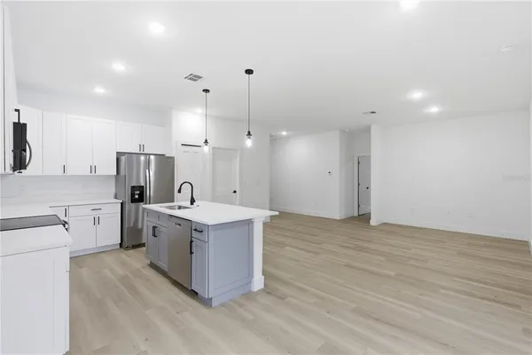 a kitchen with a stove a refrigerator and a oven