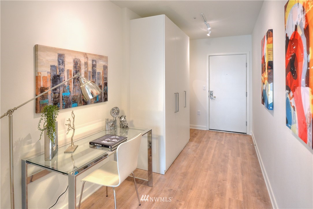 1601 North 45th Street, Unit 411 Seattle, WA 98103 - Photo 12 of 33 a view of a hallway with wooden floor and furniture