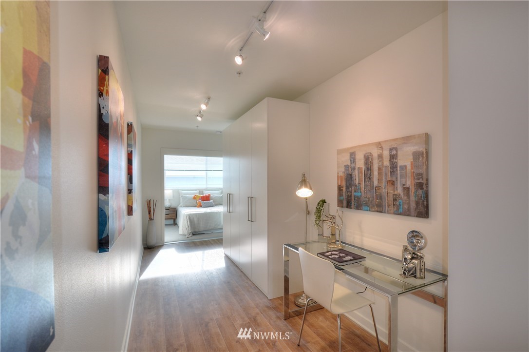 1601 North 45th Street, Unit 411 Seattle, WA 98103 - Photo 14 of 33 a view of a hallway with furniture and wooden floor