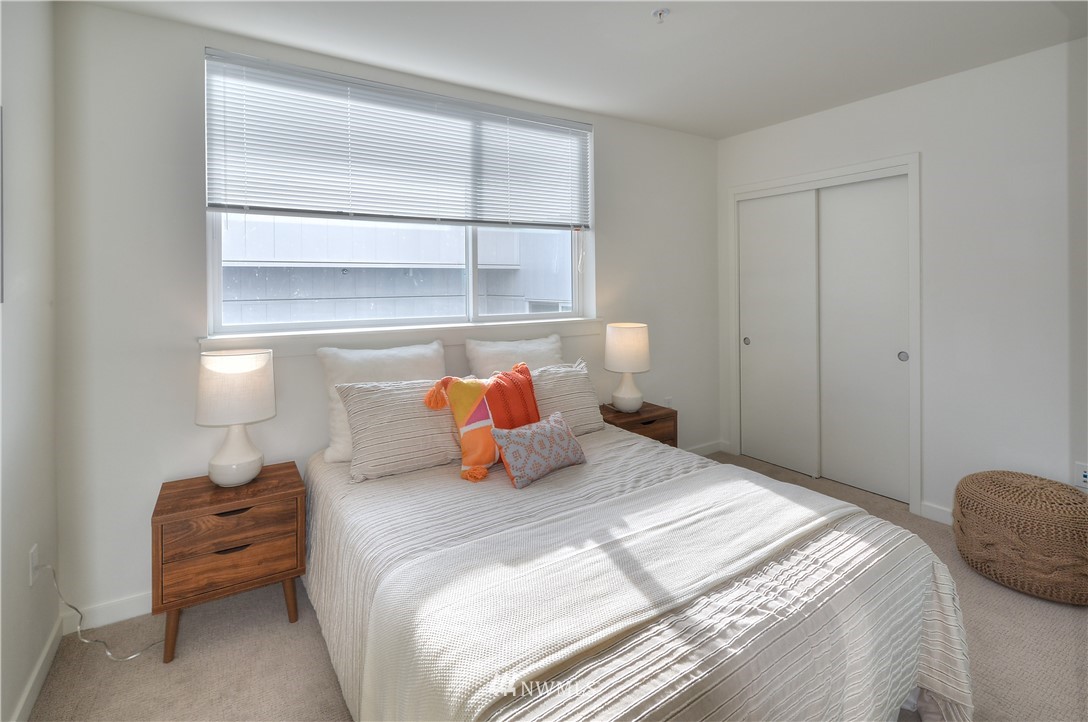 1601 North 45th Street, Unit 411 Seattle, WA 98103 - Photo 15 of 33 a bedroom with a bed and wooden floor