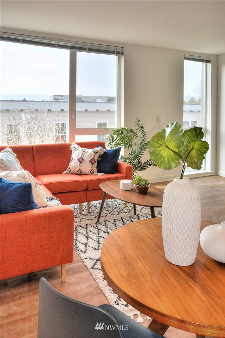 1601 North 45th Street, Unit 411 Seattle, WA 98103 - Photo 20 of 33 a living room with furniture and floor to ceiling windows
