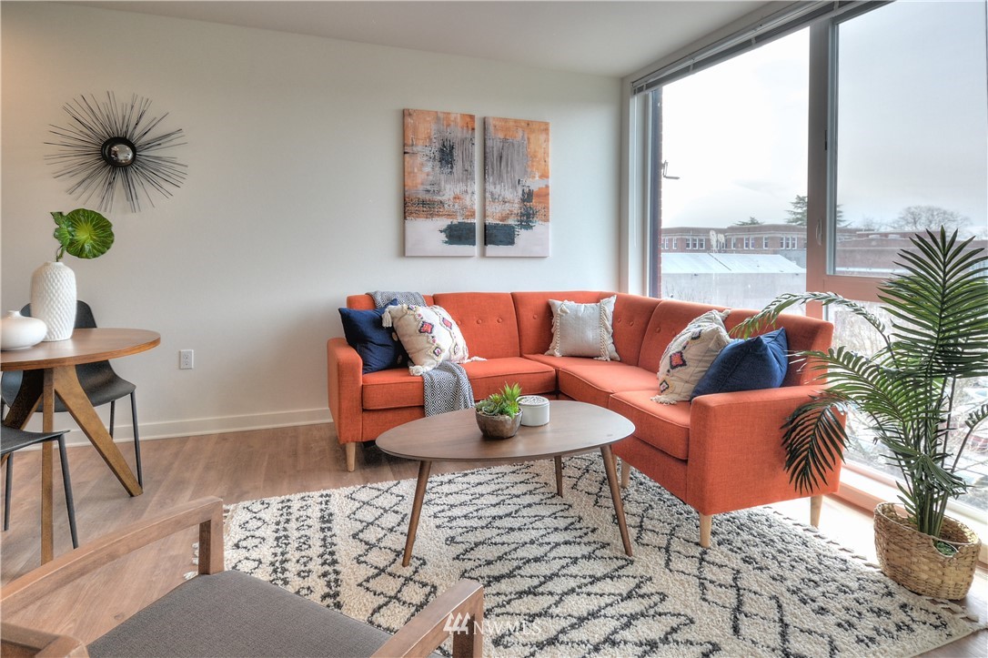 1601 North 45th Street, Unit 411 Seattle, WA 98103 - Photo 26 of 33 a living room with furniture and a potted plant