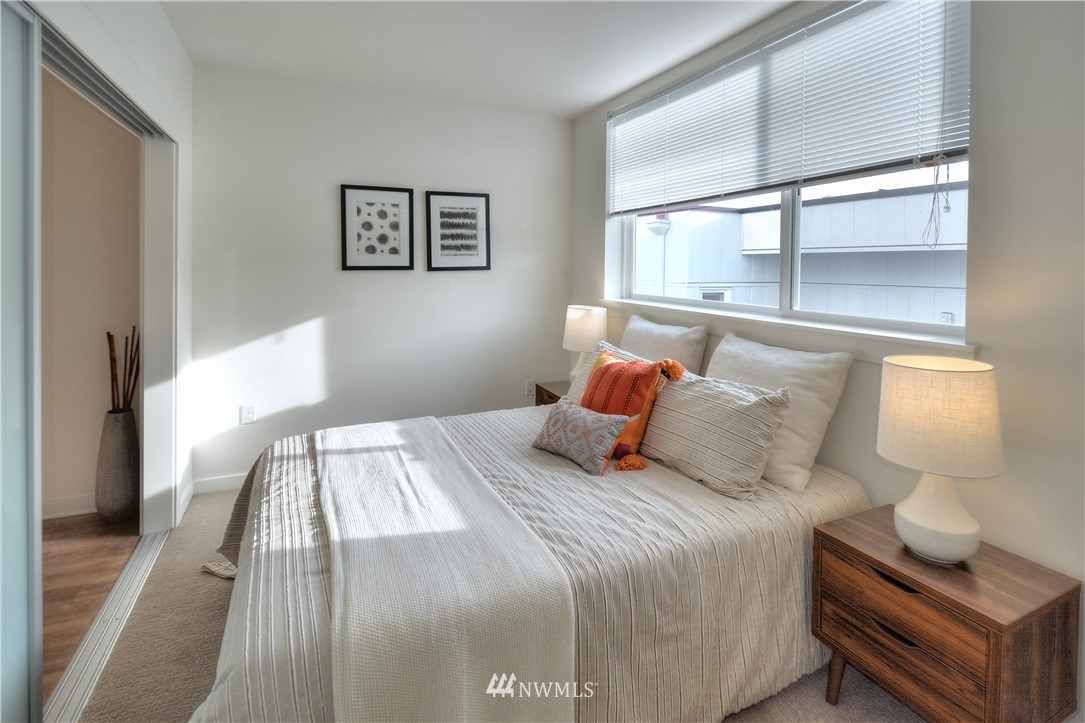 1601 North 45th Street, Unit 411 Seattle, WA 98103 - Photo 32 of 33 a bedroom with a bed and wooden floor