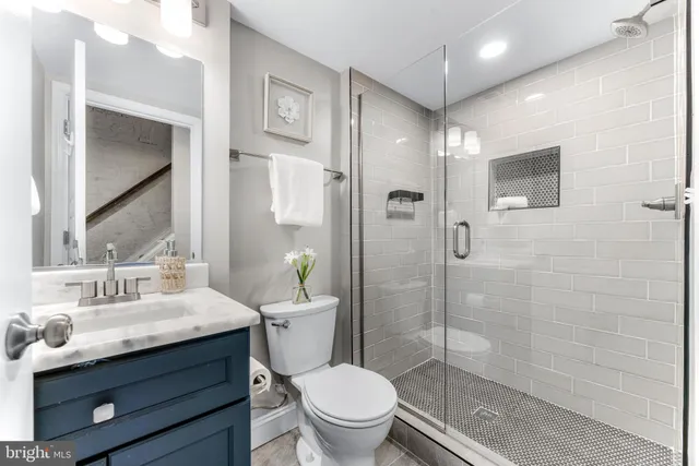 a bathroom with a sink toilet and shower