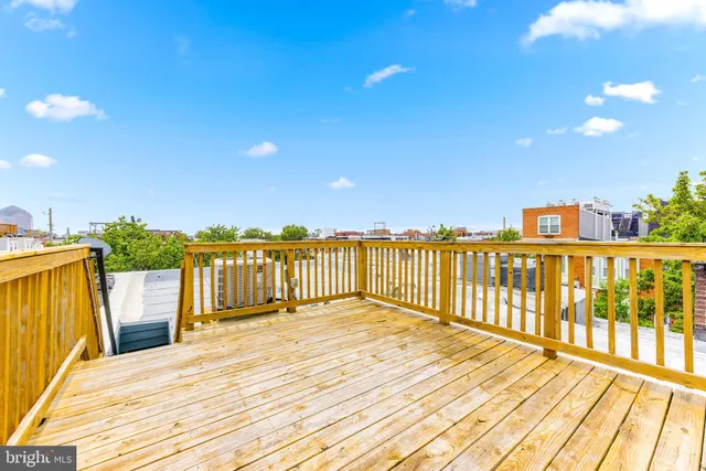 a view of a balcony with wooden floor