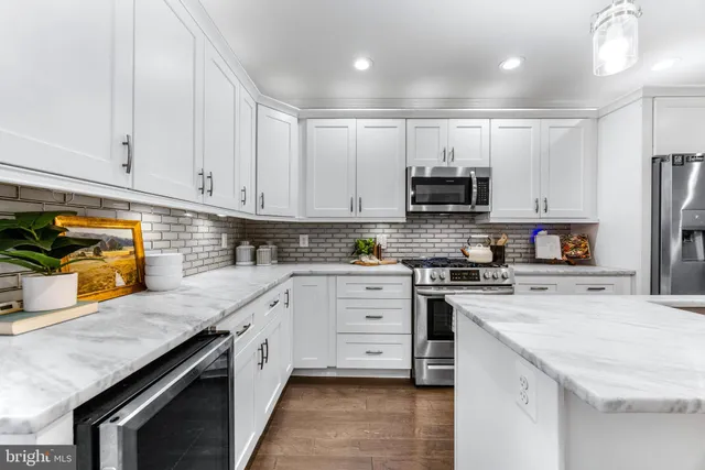 a kitchen with granite countertop a stove sink and cabinets
